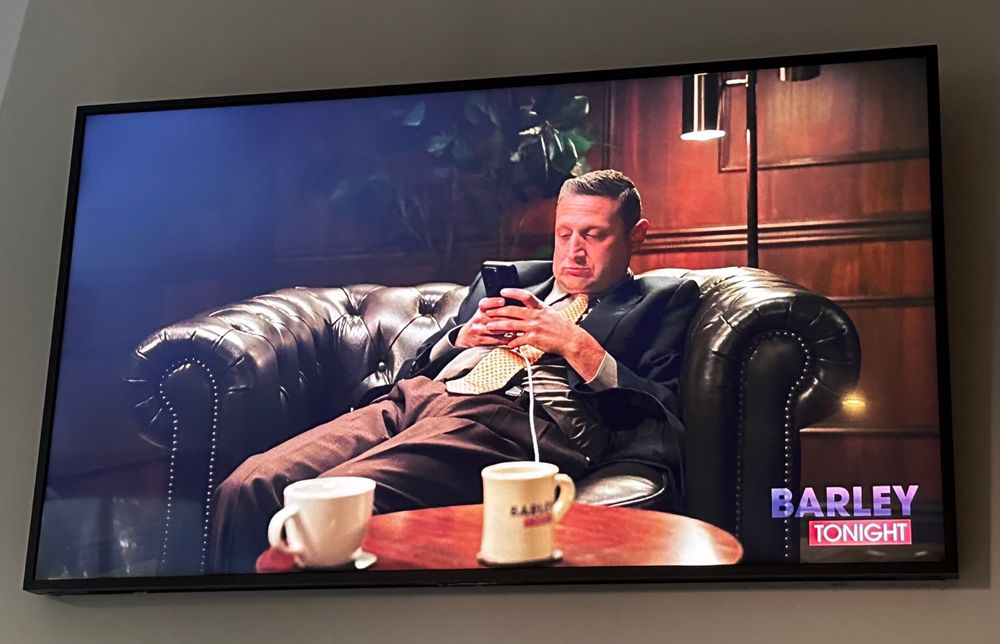 I Think You Should Leave screenshot of sad man looking at his phone on a couch. 