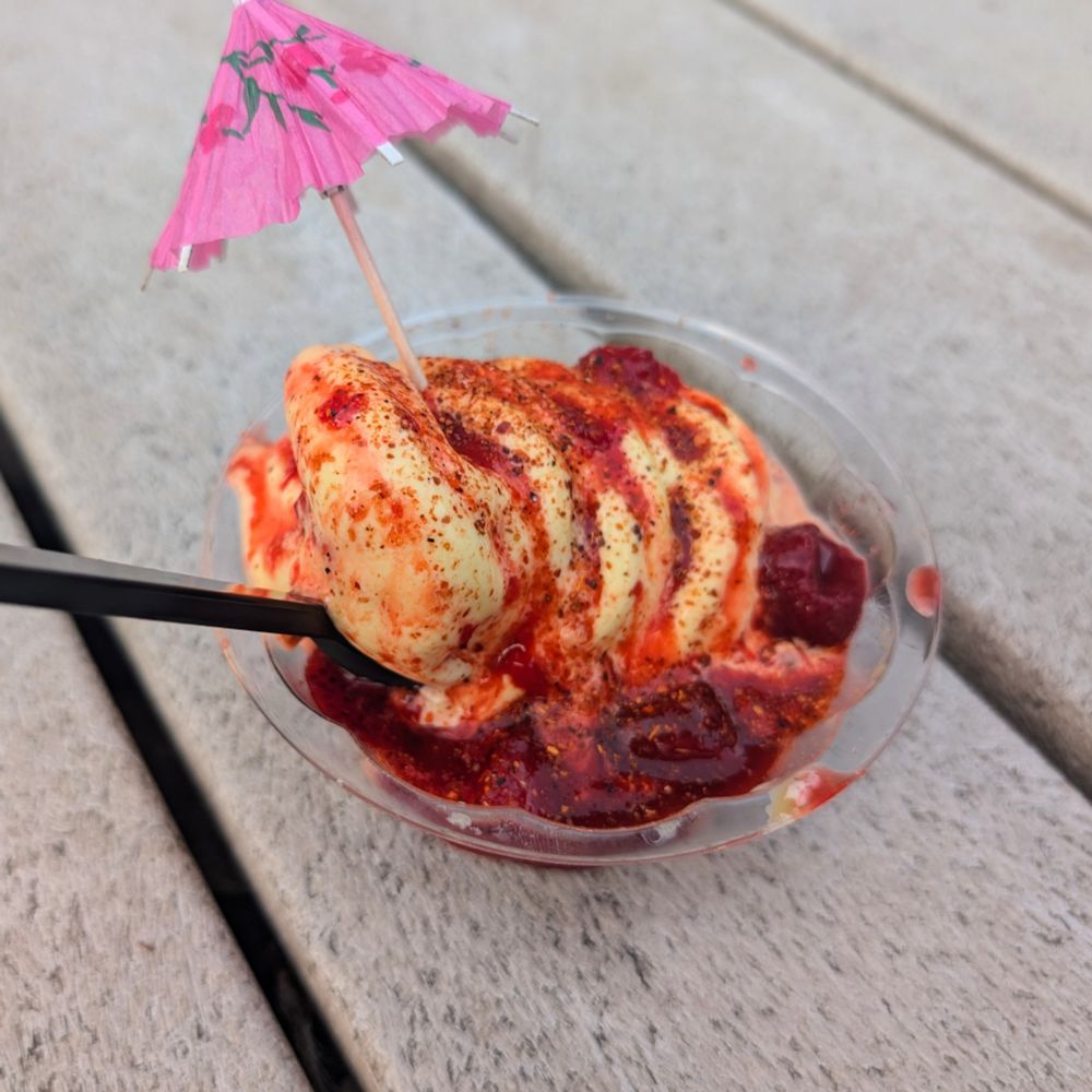 Mango Dole whip with strawberries, champy, tajín and a little umbrella 