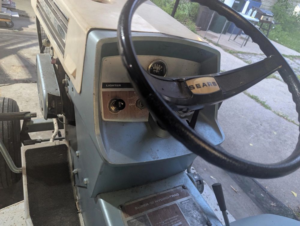 An old Sears riding mower with a cigarette lighter