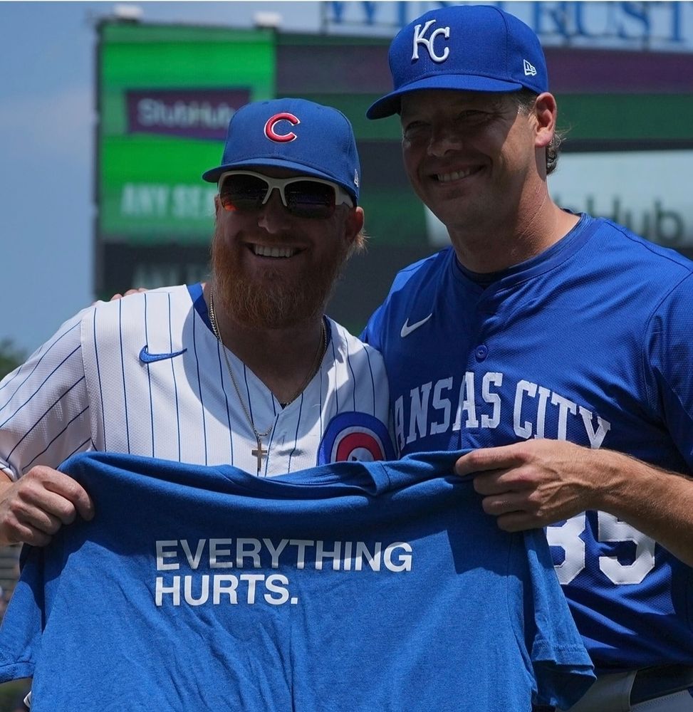 jt and Richie holding up a shirt that says everything hurts