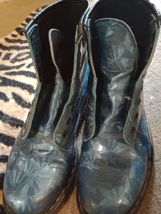pair of blue and grey Doc Martens with holographic patterns on them