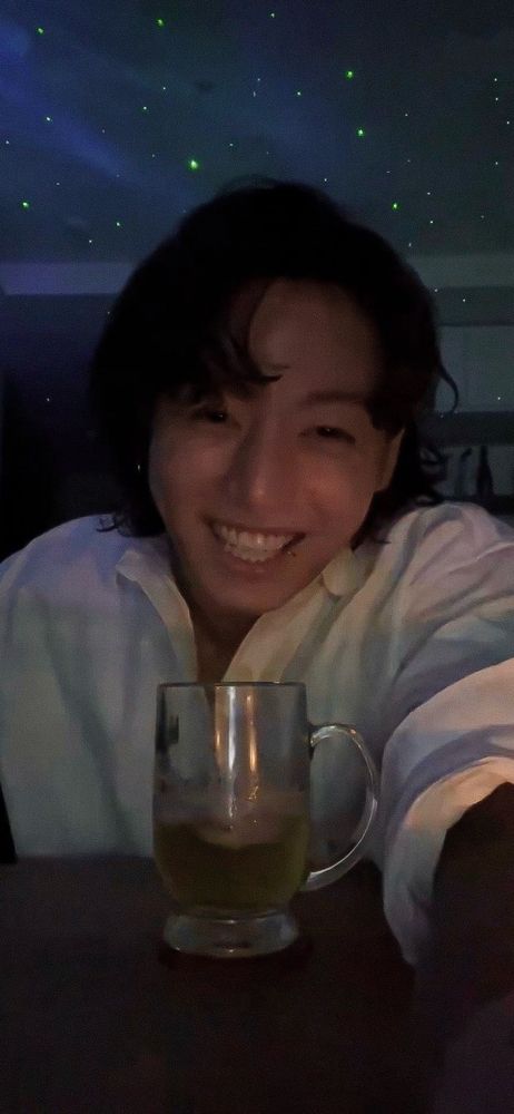 Jungkook smiling during a livestream