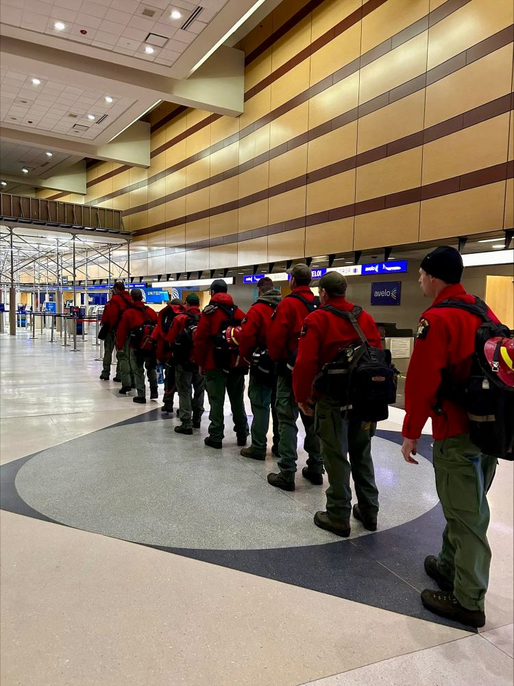 DEC Forest Rangers walking through Albany Airport. 