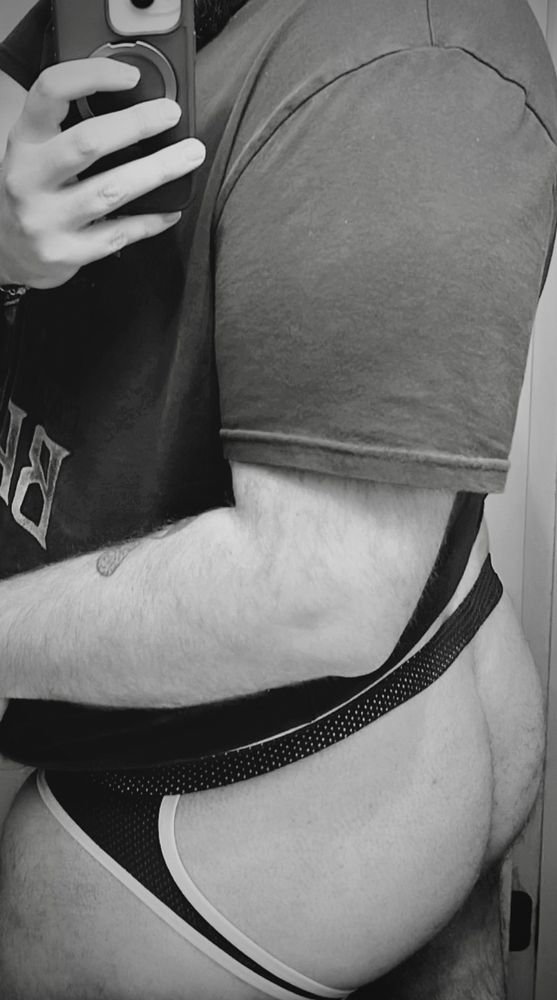 A moody black and white photo of me in a mesh jock
