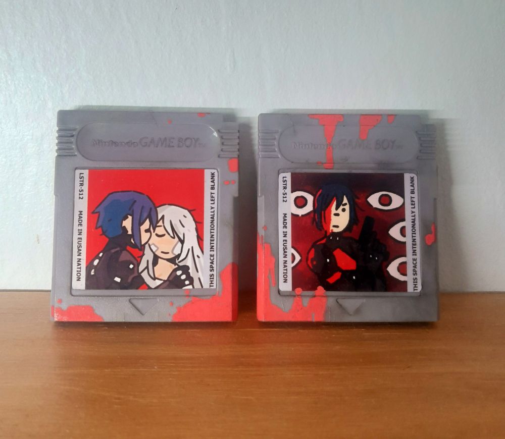 Game boy cartridges with homemade stickers of the game Signalis. Painted and bruised like Plamo 