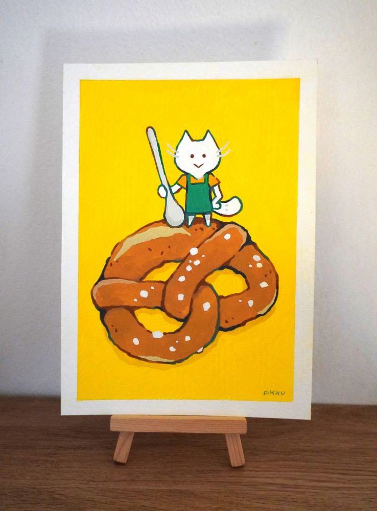Gouache painting of a white cat holding a spoon on a Bretzel 