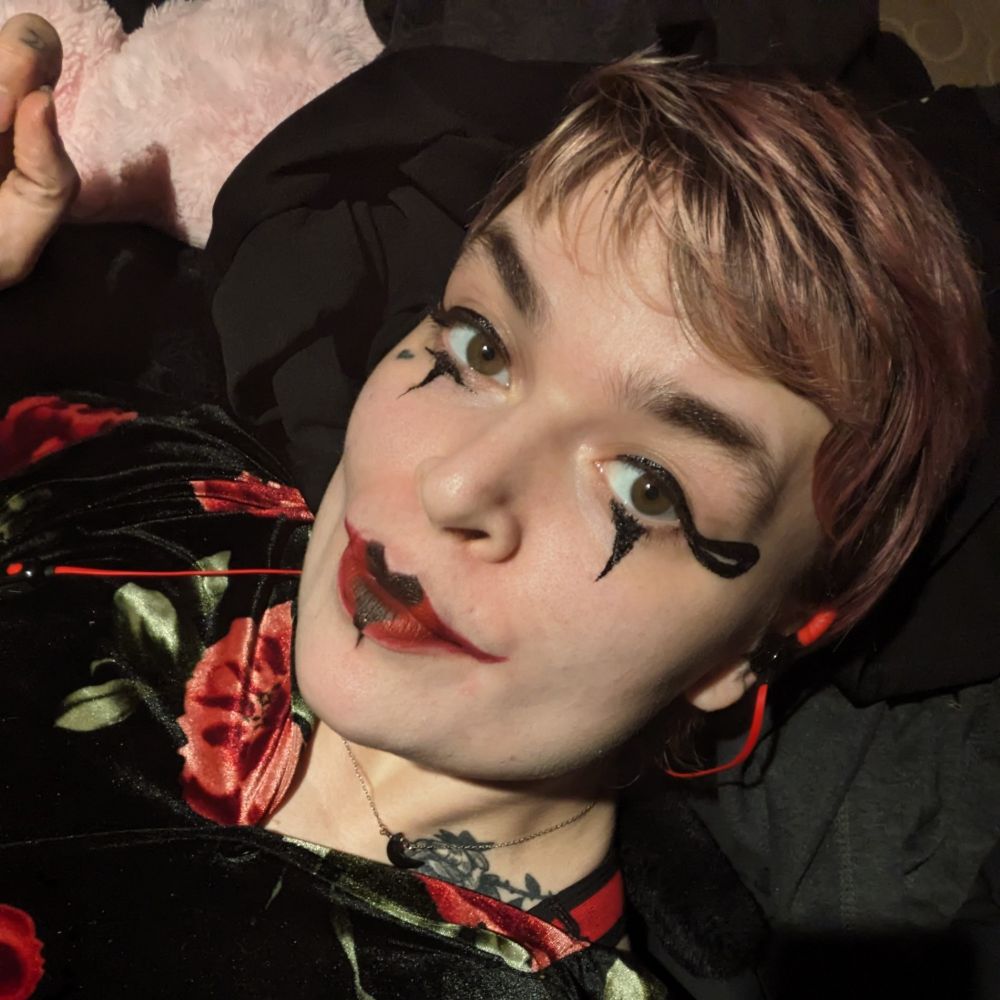 lush with red and black clown makeup on