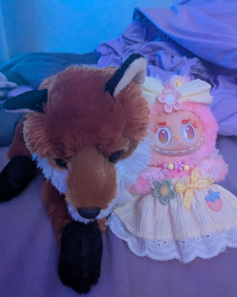 a fox plush named sunset cuddling a loyalty labubu named Lulu