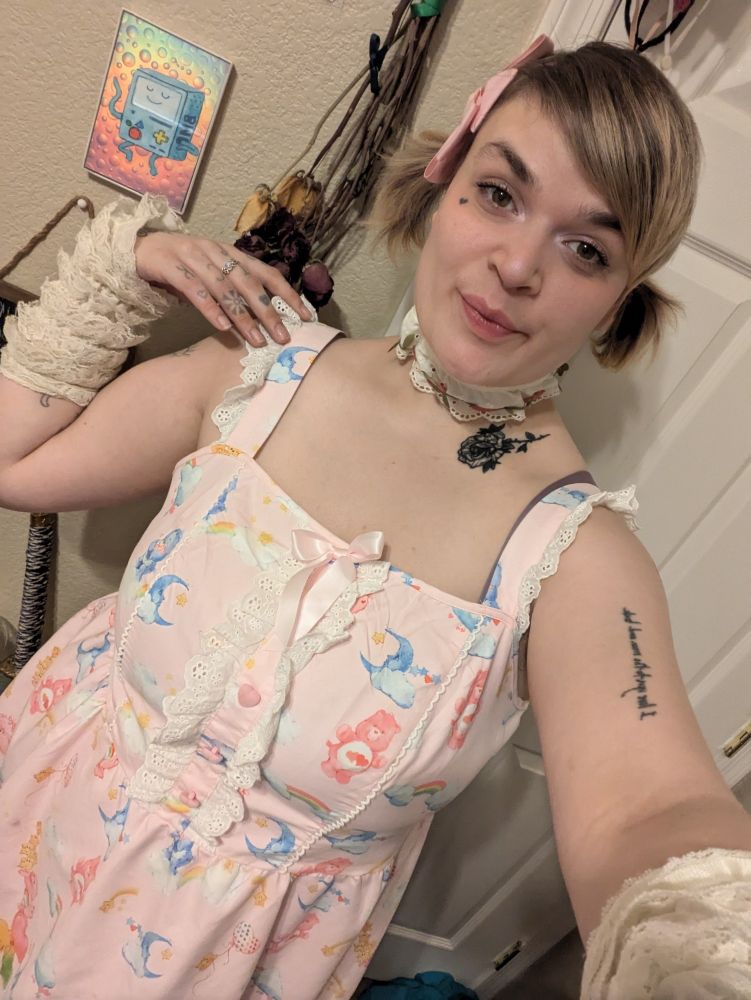 Lush wearing pigtails and a carebear dress