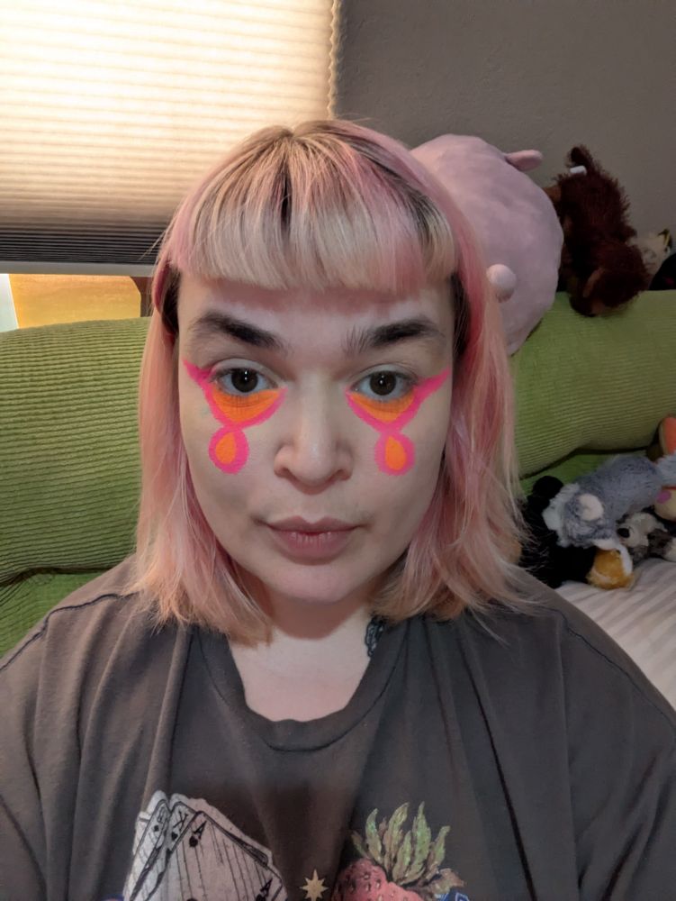 Me with some interesting and bright pink and orange eyeliner under my eyes
