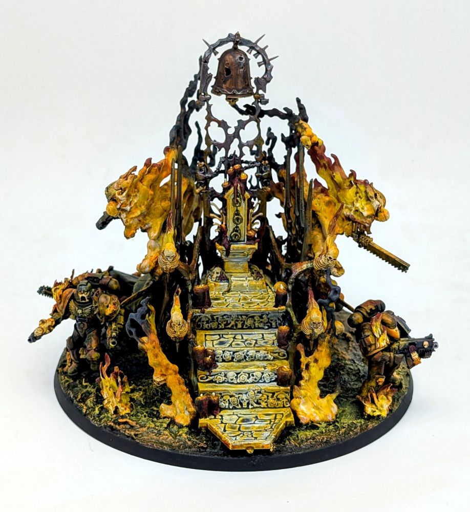 A sepulchre wreathed in flames. A large bronze bell hangs overhead. Skeletal warriors and space Marines emerge from the flames