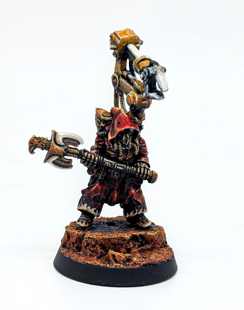 A 1988 era Rogue Trader model with converted servo arm. He is holding an axe. The robed model is painted in a Blanche style of artwork. 