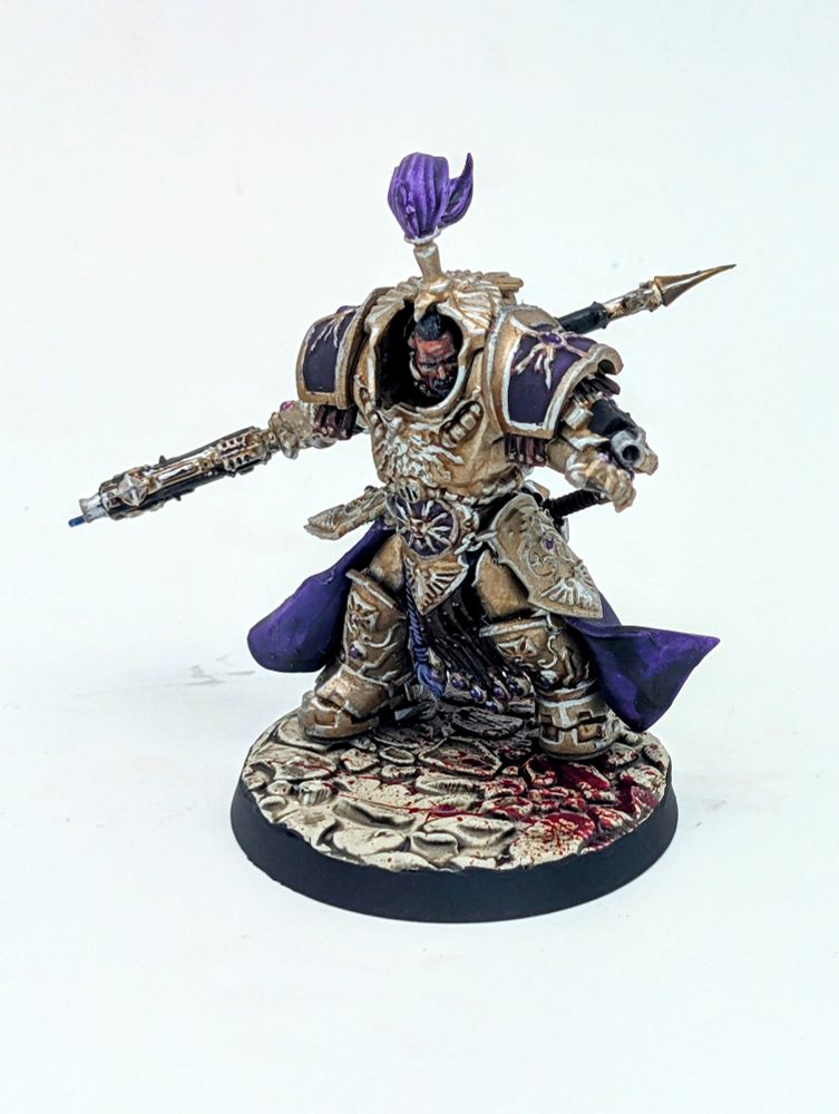 A golden armored warrior with a power axe and purple cloak. His armor is covered in lightning and eagle motiffs