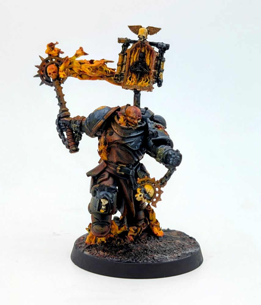 A Black armored marine with flaming armor wields a flaming staff