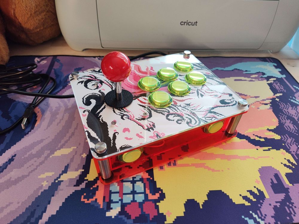 Angled shot of my okami mini arcade stick, bright green buttons on fluorescent pink acrylic.