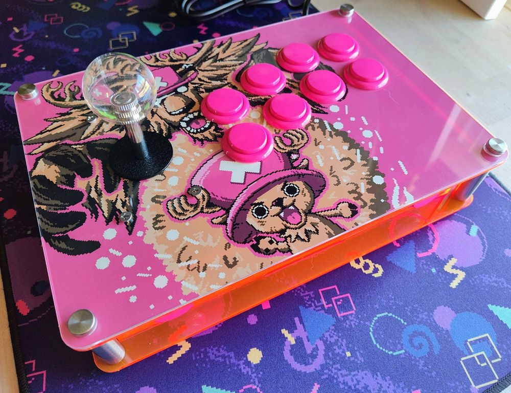Astra Arcade custom fight stick made out of fluorescent pink acrylic. The art on the front plate is Chopper from One Piece with his berserk form behind. All the buttons are an opaque pink with a clear balltop.