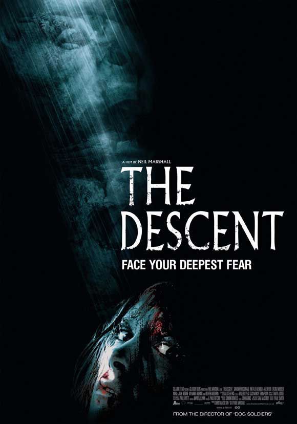 A movie poster for The Descent depicts mostly darkness, with a small shaft of light illuminating creepy faces and finally a woman's face at the bottom of the image. Tagline: Face your deepest fear.