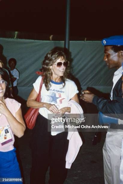 Jane Fonda in the 1980s wearing a 1984 Los Angeles Olympics tee and sunglasses