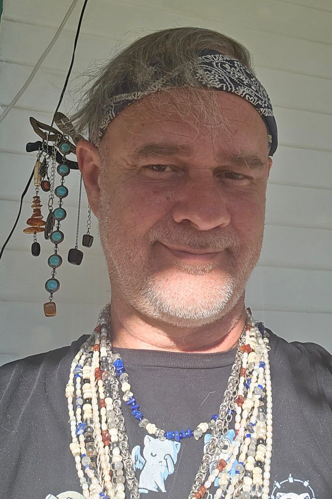 Today's selfie. Layers of my necklaces and 3 of my hair sticks tucked into my bandana. Shadow and light dividing my head.