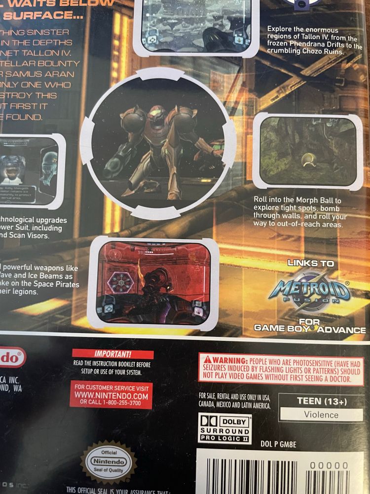 The back cover of Metroid Prime featuring a logo that says links to Metroid fusion for the game boy advanced.
