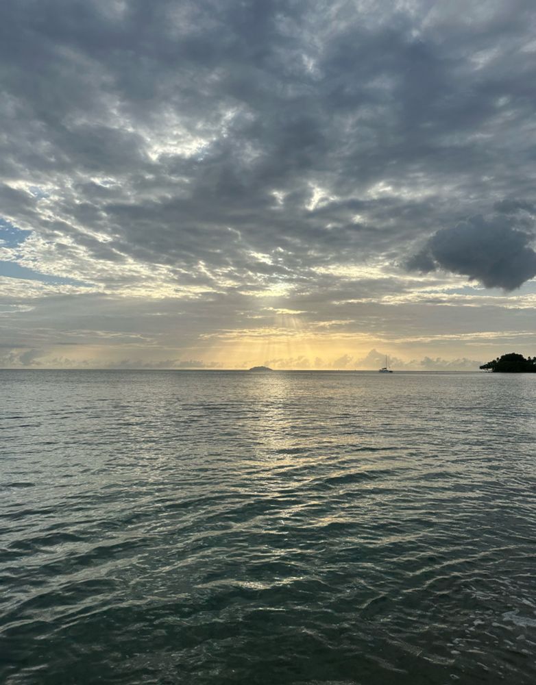 Sunset shining through clouds over the ocean