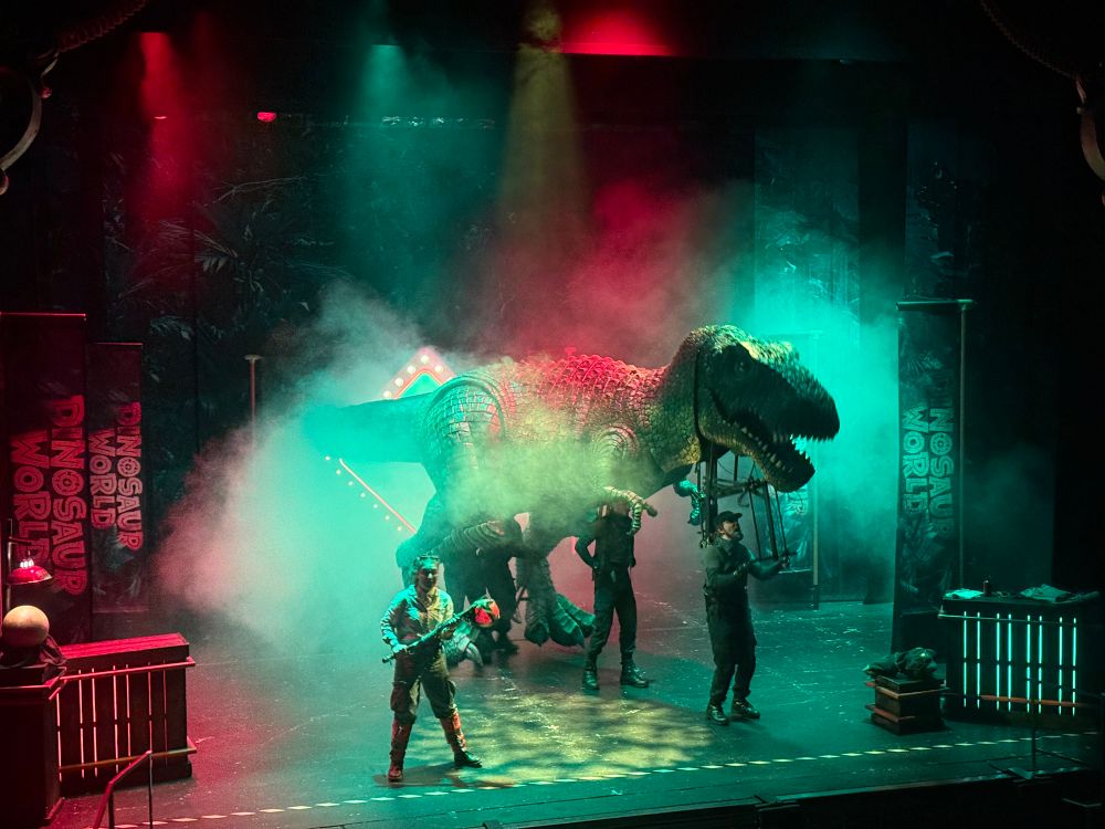 A menacing T-Rex appears on stage!