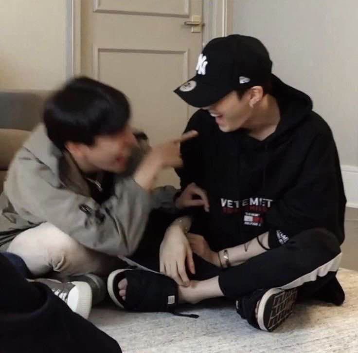 Hobi and Yoongi laughing. Hobi is blurry but Yoongi isn't.