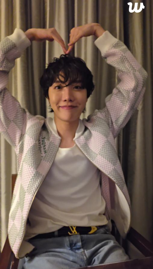 Hobi making a heart with his arms