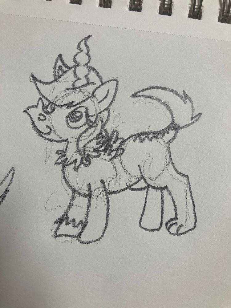 A young pony with a large donkey snout, one single gazelle horn protruding from her forehead, a weird snake tail thing, as well as mismatched paws and wings.