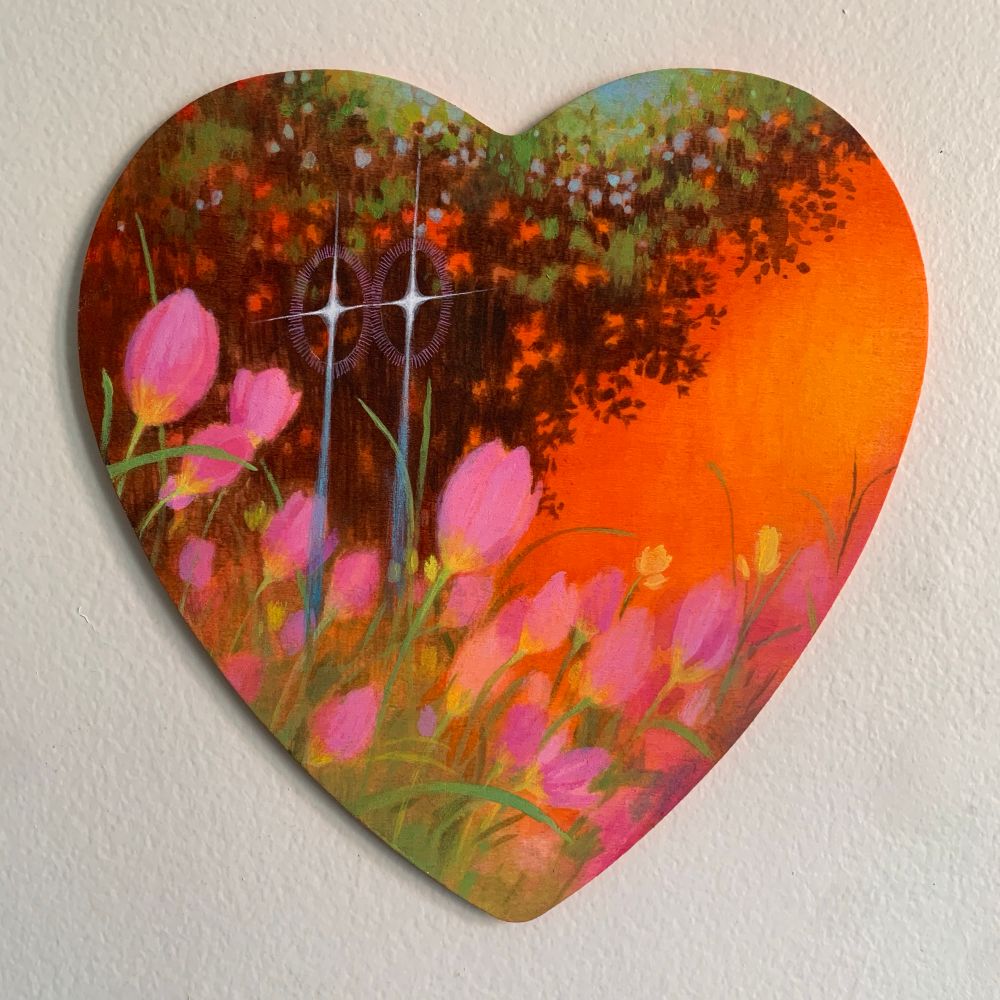 A heart shaped painting against a white background. The painting depicts a warm scene with orange background, a large brown tree on the left and pink tulips in the foreground. Floating in the sky is two blue-tailed stars with small pink halos.  