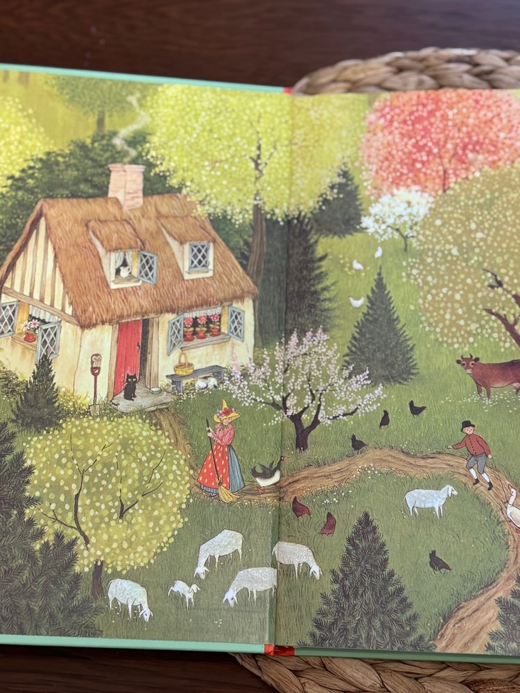 A pastoral scene unfolds in the pages of a book,