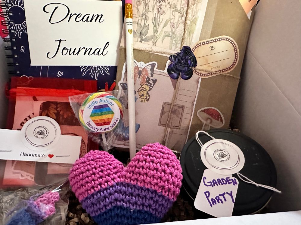 Cozy book box filled with a book, homemade candle, hand crocheted pin and stuffy, dream journal, and lots of bookish goodies