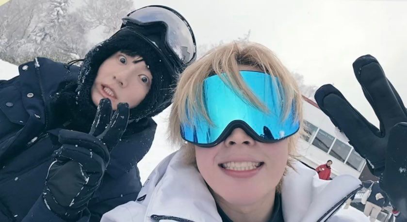 Jimin and Jungkook of BTS posing in ski gear during their travel show "Are You Sure?!".