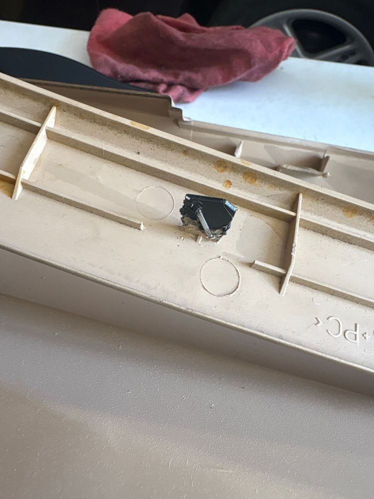 A “repaired” interior trim panel clip. Black ABS has been fused to the original part and a T50 staple has been modified and fused to the two parts for added reinforcement 