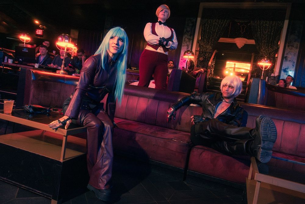 Photo of Zerggiee.bsky.social, piggynukka.bsky.social & Maguma cosplaying from King of Fighters at the SNK World Championships in 2024. Photo by Tempus Rob