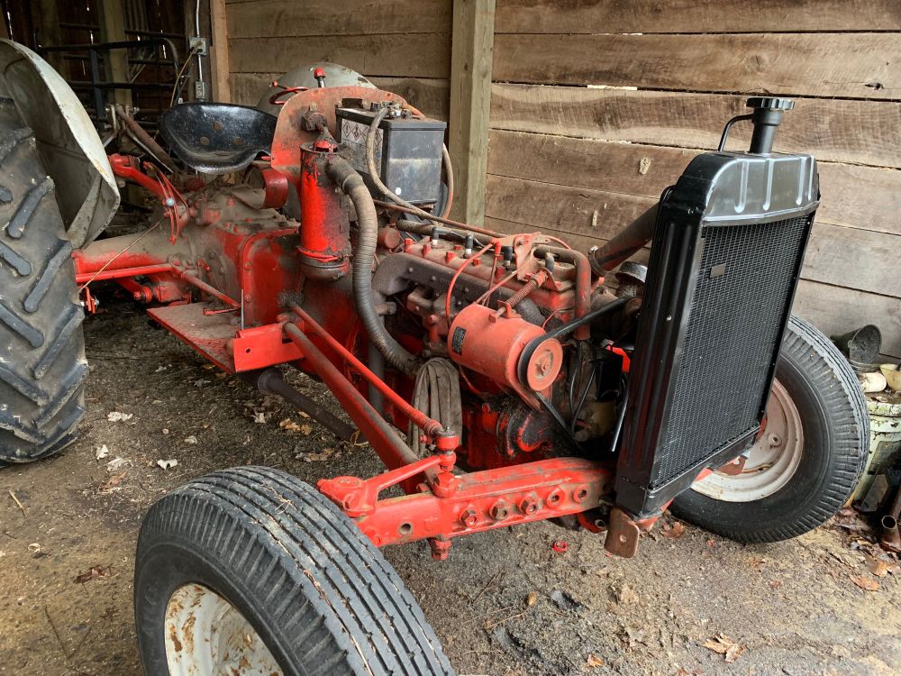 Tractor torn down for repair with new black radiator.