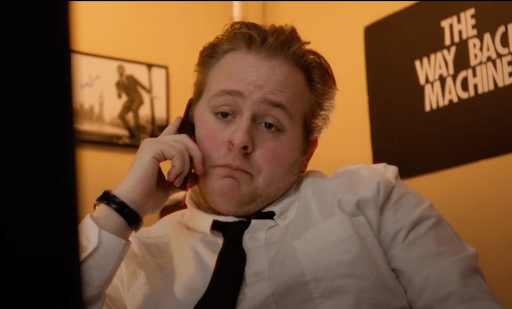 A frame of Dylan Cote from the short film 'THE WAYBACK MACHINE,' a short film by Diego Diaz and Can Sark, which earned an Honorable Mention for the 2025 Public Domain Day Remix Contest. 