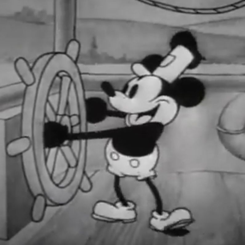 Iconic image of Mickey Mouse standing at the wheel of a steamboat.