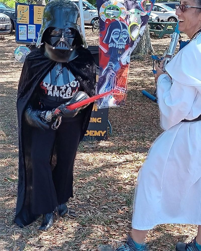 Playful lightsaber duel between Vader and Leia brings energy and fun to the event.