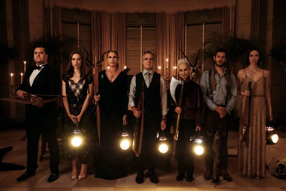 The rich family from Ready or Not (2013) standing shoulder to shoulder with weapons and/or lanterns in hand