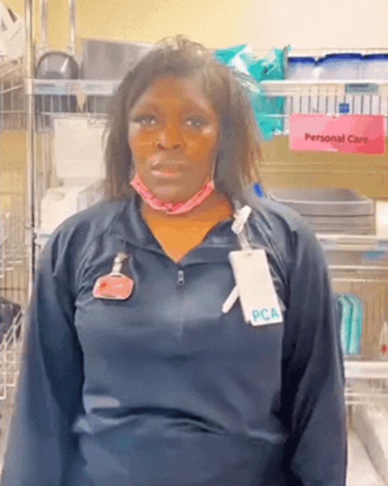 a woman wearing a mask and a name tag with the word pca on it