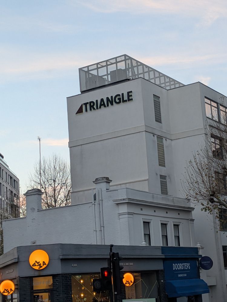 building with the word "triangle" on it with a right angled triangle shape on its left

the is also a building with a circle logo underneath 
