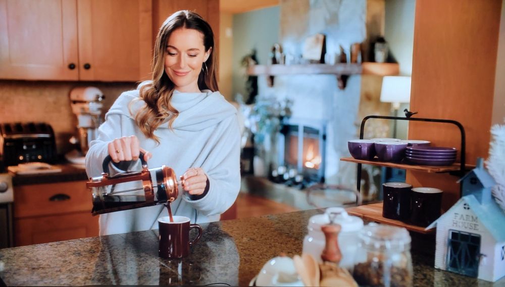 A generic looking scene of a woman pouring coffee.