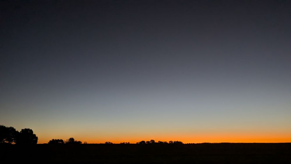 Image of a sunrise over a harvested Midwest US field