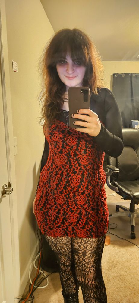 ashley wearing a red, floral print dress. she is smiling :)