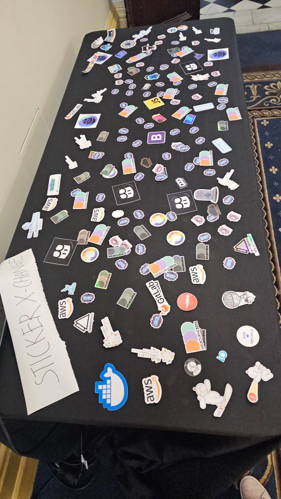 Table of stickers with a few stickers on a black table cloth.