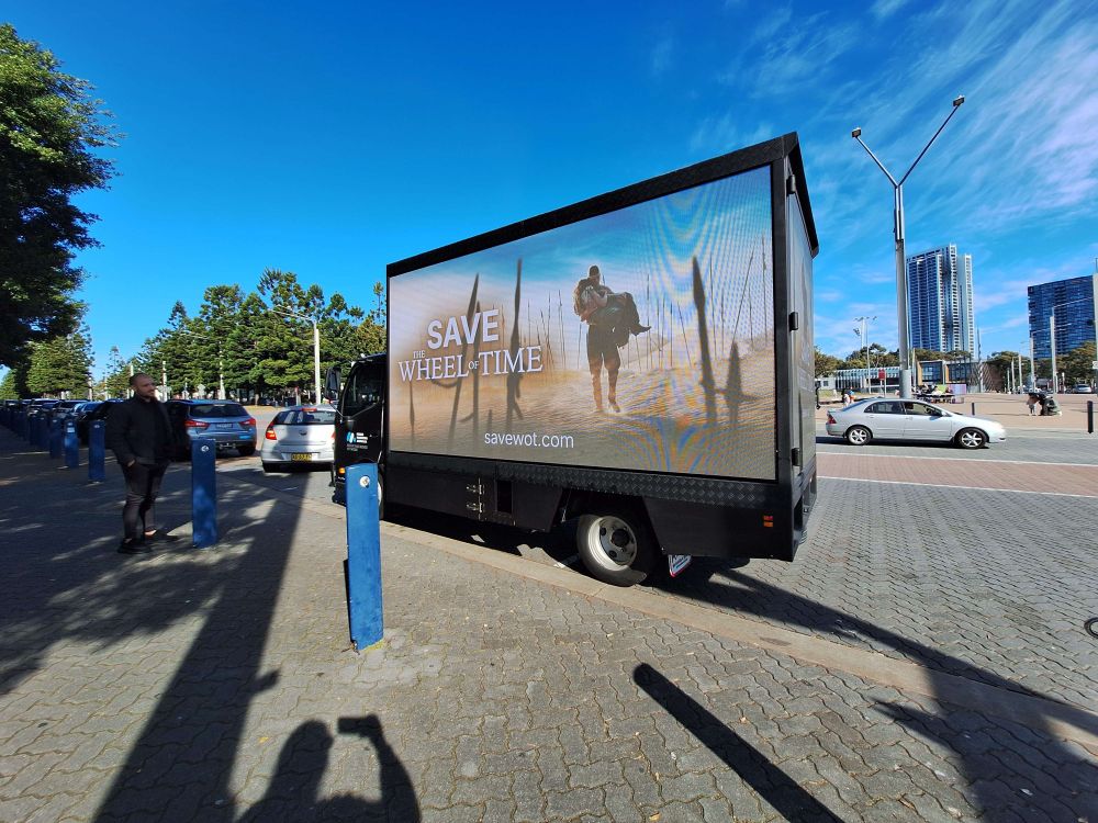 Picture of small truck with led panels mounted all around this one has Rand carrying Moiraine out of Rhuidean through the spears on it 