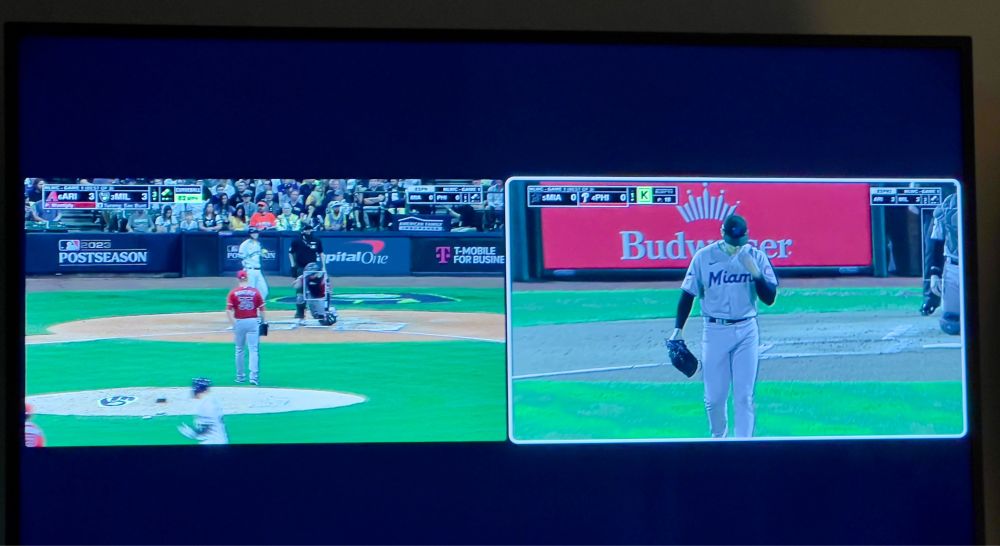 Television screen with two different baseball games occupying half of the screen.