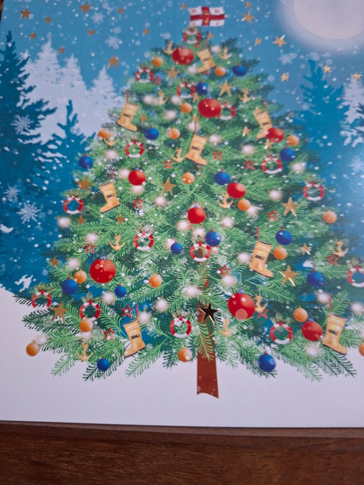 Xmas card showing Xmas tree with St George flag with RNLI on it.
