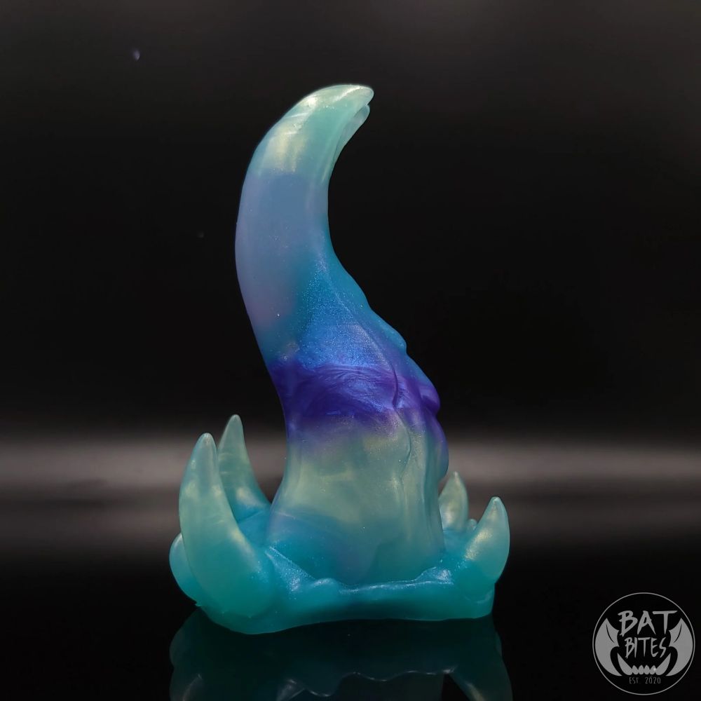 This is my small Spire which I purchased in February 2023. This Rainbow Fluorite coloration is a translucent marble of pearly seafoam green, aqua, purple, and clear.